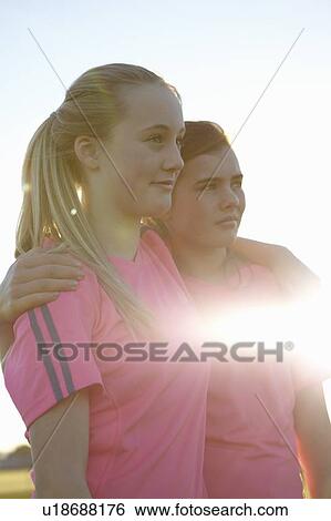 Stock Photograph - Girls smiling together outdoors. Fotosearch