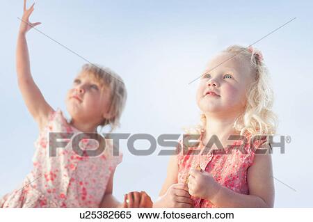 Stock Photography - Girls standing together outdoors. Fotosearch