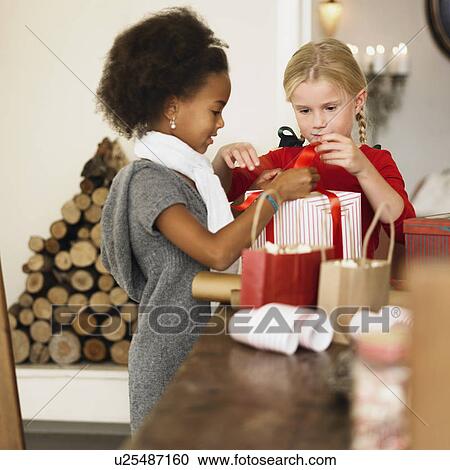 Girls wrapping Christmas presents View Large Photo Image Stock Image - Girls wrapping Christmas presents. Fotosearch