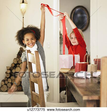 Girls wrapping Christmas presents View Large Photo Image Stock Photography - Girls wrapping Christmas presents. Fotosearch