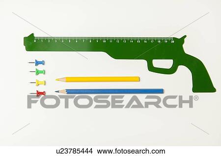 Picture - Gun shaped ruler and office supplies. Fotosearch