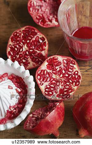 Halved pomegranates with juice View Large Photo Image Stock Photo - Halved pomegranates with juice. Fotosearch