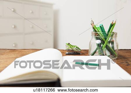 Jar of pencils and notebook on table View Large Photo Image Stock Photograph - Jar of pencils and notebook on table. Fotosearch