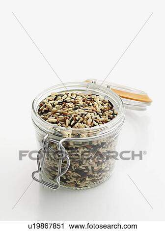 Stock Image - Jar of raw wild rice. Fotosearch