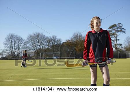 Lacrosse player standing in field View Large Photo Image Stock Photo - Lacrosse player standing in field. Fotosearch