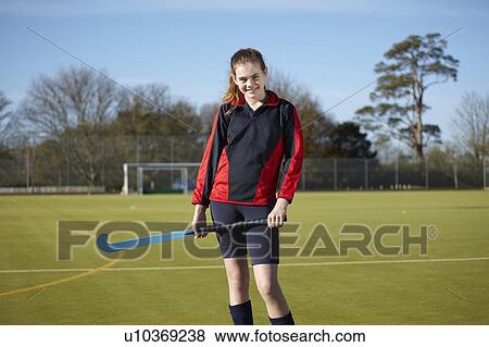 Lacrosse player standing on field View Large Photo Image Stock Photo - Lacrosse player standing on field. Fotosearch