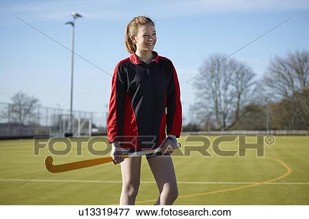 Stock Photo - Lacrosse player standing on field. Fotosearch