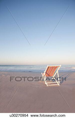 Lawn chair on empty beach View Large Photo Image Picture - Lawn chair on empty beach. Fotosearch