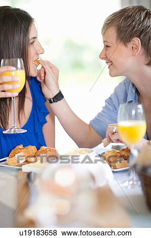 Lesbian couple having breakfast together View Large Photo Image Stock Photo - Lesbian couple having breakfast together. Fotosearch