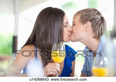 Lesbian couple kissing at table View Large Photo Image Stock Image - Lesbian couple kissing at table. Fotosearch
