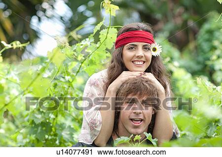 Man carrying girlfriend in tall plants View Large Photo Image Stock Image - Man carrying girlfriend in tall plants. Fotosearch