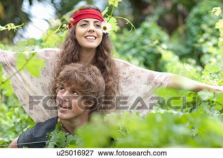 Man carrying girlfriend in tall plants View Large Photo Image Stock Photo - Man carrying girlfriend in tall plants. Fotosearch