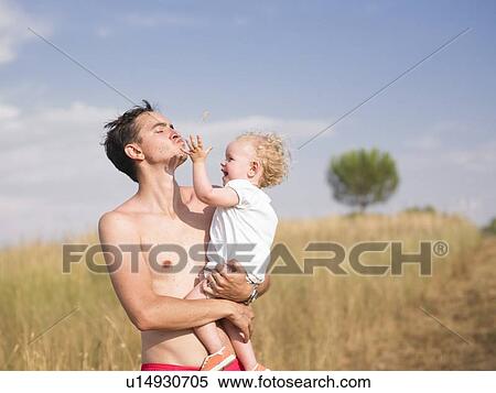 Man carrying son outdoors View Large Photo Image Stock Photography - Man carrying son outdoors. Fotosearch