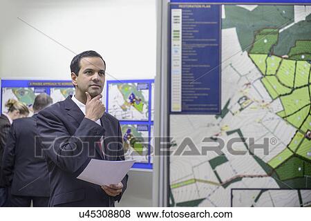 Stock Photo - Man considering town hall proposal. Fotosearch