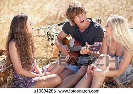 Man playing guitar for friends View Large Photo Image Stock Photography - Man playing guitar for friends. Fotosearch