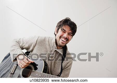 Man playing guitar outdoors View Large Photo Image Stock Photography - Man playing guitar outdoors. Fotosearch