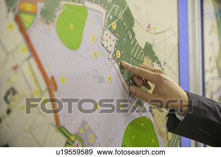 Man pointing at map of proposal View Large Photo Image Stock Photo - Man pointing at map of proposal. Fotosearch