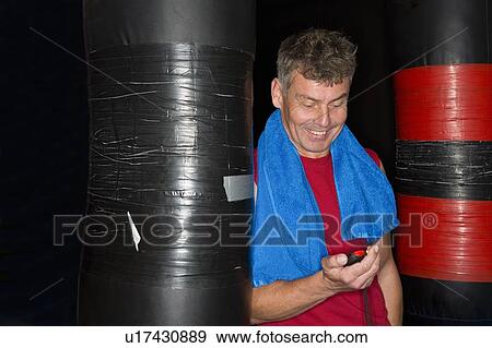Man reading stopwatch in gym View Large Photo Image Stock Photo - Man reading stopwatch in gym. Fotosearch