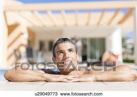 Man resting on edge of swimming pool View Large Photo Image Stock Image - Man resting on edge of swimming pool. Fotosearch