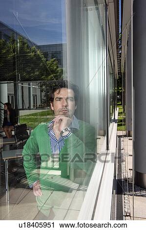 Man standing behind window View Large Photo Image Stock Image - Man standing behind window. Fotosearch