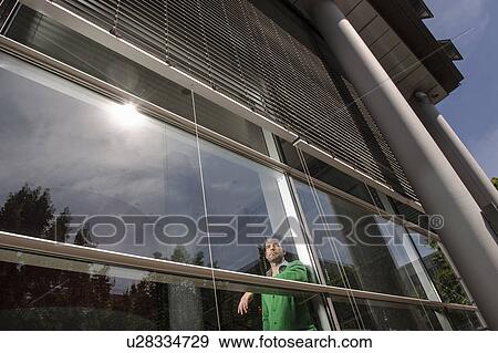 Man standing behind window View Large Photo Image Stock Photo - Man standing behind window. Fotosearch