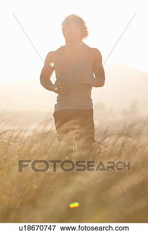 Man standing in tall grass View Large Photo Image Stock Photo - Man standing in tall grass. Fotosearch