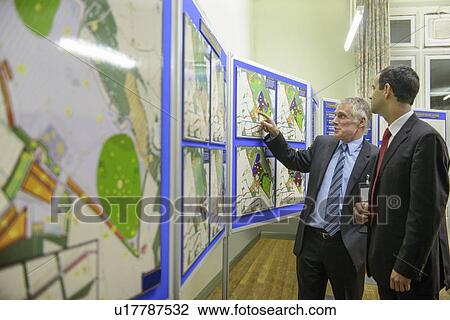 Stock Image - Man talking with town hall staff. Fotosearch