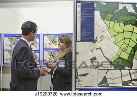 Stock Photo - Man talking with town hall staff. Fotosearch