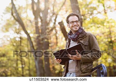 Picture - Man using tablet computer in forest. Fotosearch