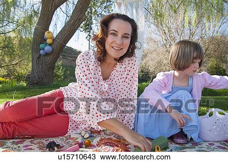 Stock Image - Mother and daughter having picnic. Fotosearch