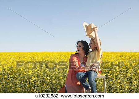 Mother and daughter in field of flowers View Large Photo Image Stock Image - Mother and daughter in field of flowers. Fotosearch