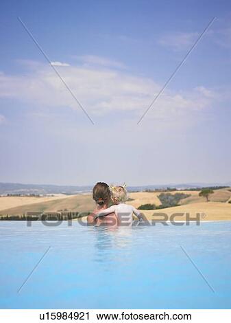 Stock Image - Mother and daughter in swimming pool. Fotosearch