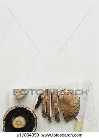 Mushroom on cutting board View Large Photo Image Stock Image - Mushroom on cutting board. Fotosearch
