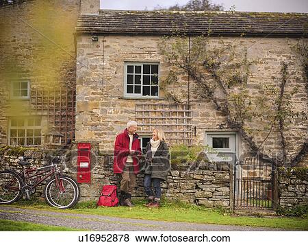 Older couple by stone wall in village View Large Photo Image Stock Photo - Older couple by stone wall in village. Fotosearch