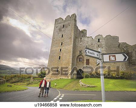 Older couple on rural road by castle View Large Photo Image Stock Photo - Older couple on rural road by castle. Fotosearch