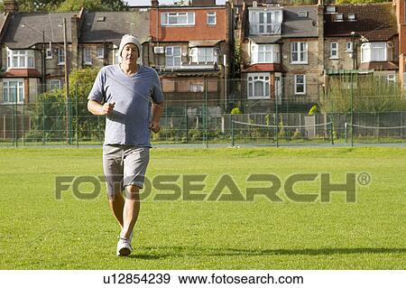 Older man jogging outdoors View Large Photo Image Stock Photo - Older man jogging outdoors. Fotosearch