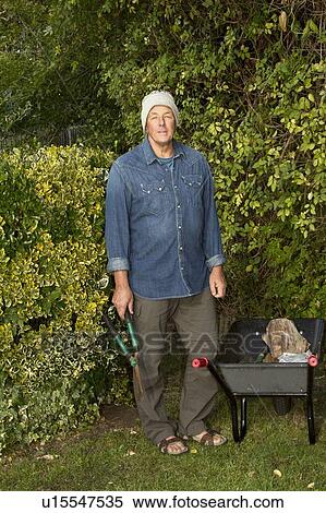 Older man working in garden View Large Photo Image Stock Photography - Older man working in garden. Fotosearch