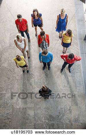 Stock Image - Overhead view of business people. Fotosearch