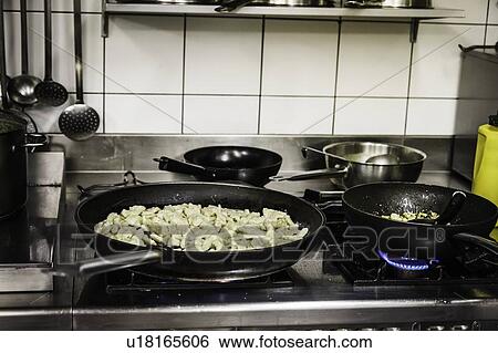 Stock Photograph - Pans of food cooking on stove. Fotosearch