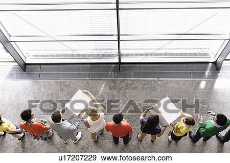 Stock Photo - People passing boxes in line. Fotosearch