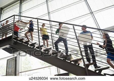 People passing boxes up stairs View Large Photo Image Picture - People passing boxes up stairs. Fotosearch