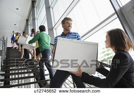 People passing boxes up stairs View Large Photo Image Stock Image - People passing boxes up stairs. Fotosearch