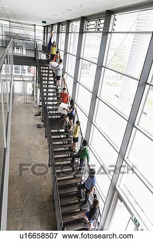 People passing boxes up stairs View Large Photo Image Stock Photo - People passing boxes up stairs. Fotosearch