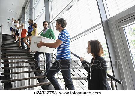People passing boxes up stairs View Large Photo Image Stock Photo - People passing boxes up stairs. Fotosearch