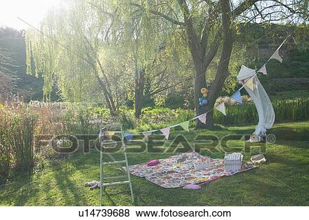 Picnic blanket and bunting outdoors View Large Photo Image Stock Photo - Picnic blanket and bunting outdoors. Fotosearch