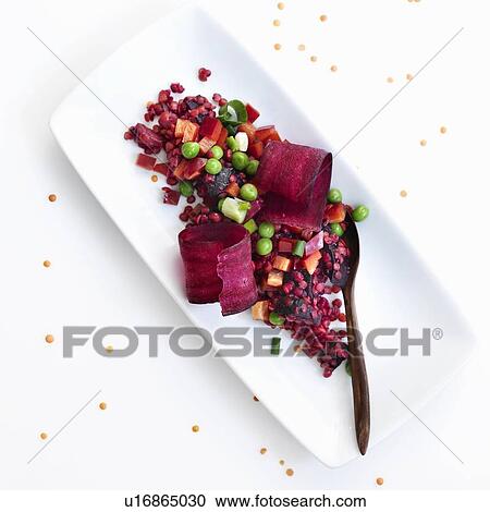 Stock Image - Plate of pea and pomegranate salad. Fotosearch