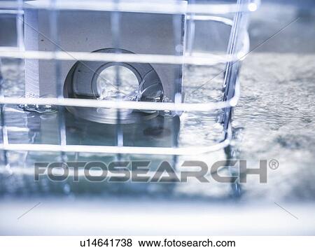 Stock Photo - Products being cleaned with ultrasonics. Fotosearch