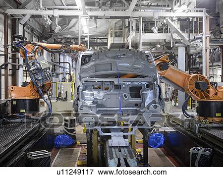Stock Photo - Robots at work in car factory. Fotosearch