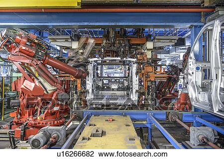 Robots welding van body in car factory View Large Photo Image Stock Image - Robots welding van body in car factory. Fotosearch
