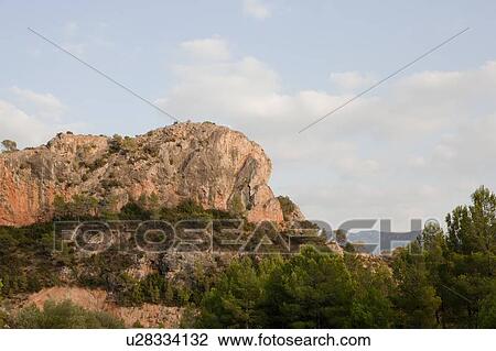 Stock Image - Rock formations on rural hilltop. Fotosearch